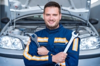 portrait-professional-handsome-car-mechanic-holding-wrenches-front-automobile-with-opened-hood_342744-261.jpg